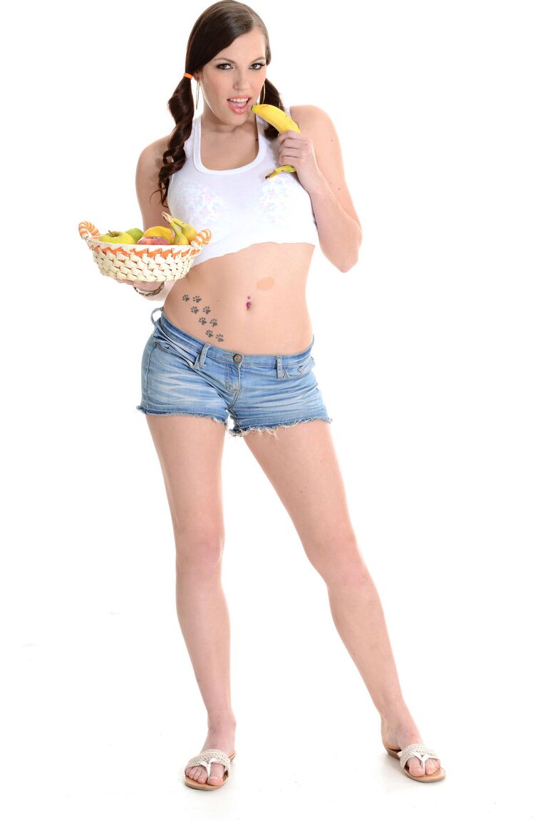 15P Cute brunette Samantha Lee eats a banana while getting naked in pigtails