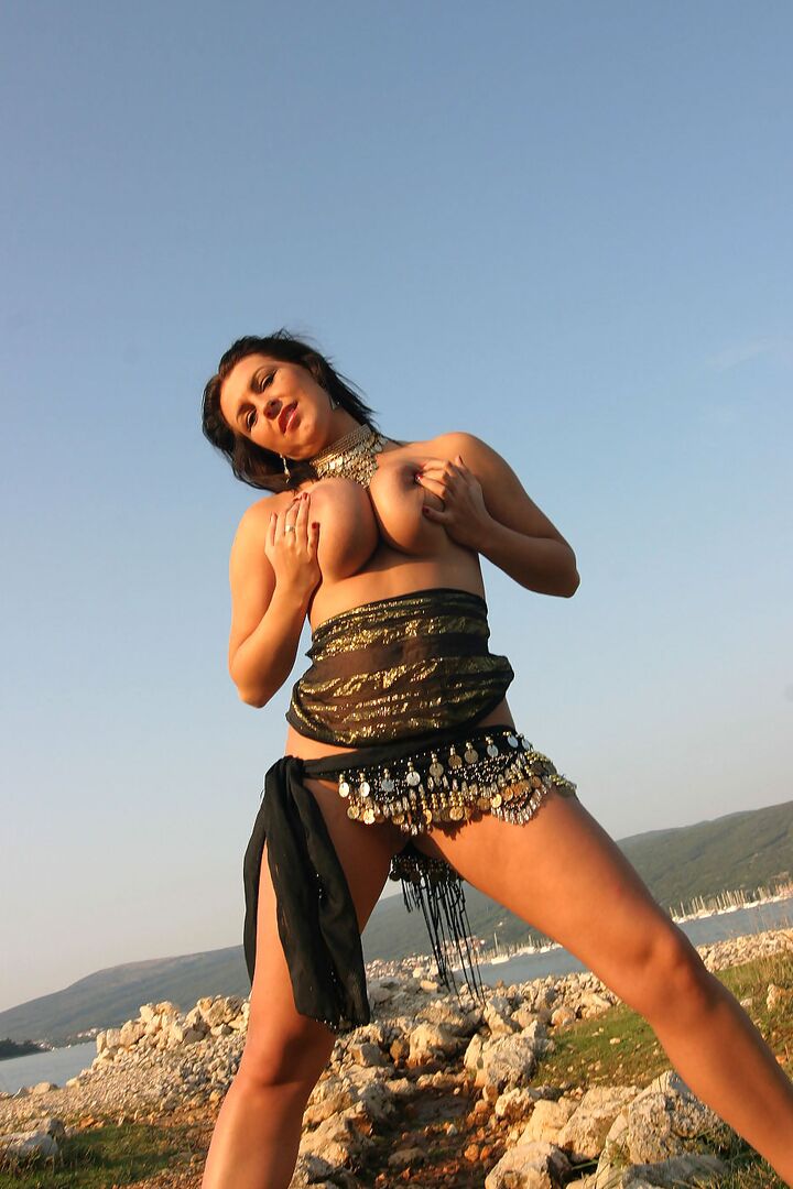 16P Solo girl Kora Kryk puts the focus on her large breasts near a body of water