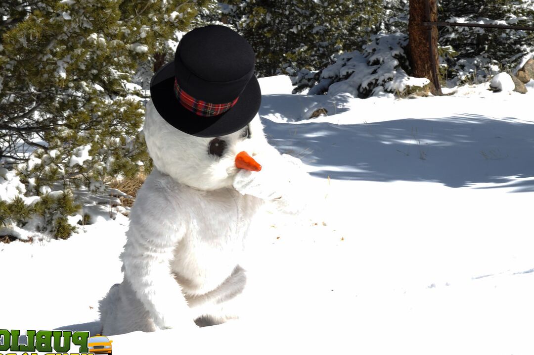 21P Naughty redhead Brandi de Lafey gives a snowman a CFNM handjob in the woods
