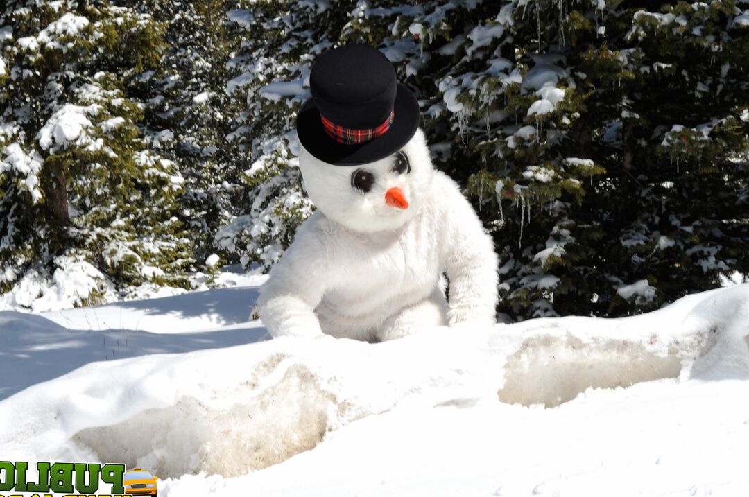 21P Naughty redhead Brandi de Lafey gives a snowman a CFNM handjob in the woods