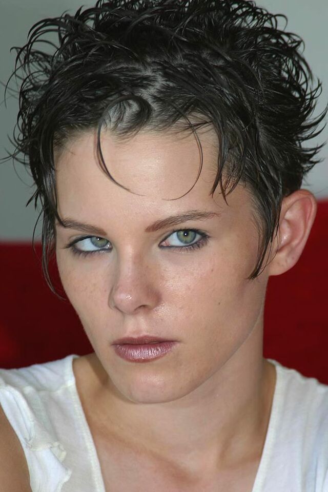 16P First timer with short hair strips naked on a red sofa for first nude poses