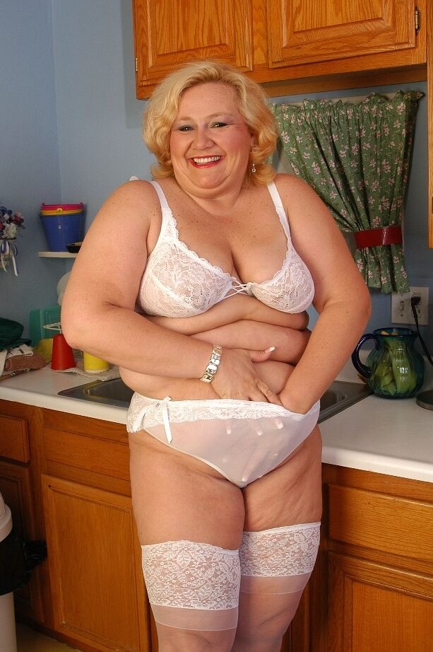 16P Older fat lady Britany models white stockings and underwear in the kitchen