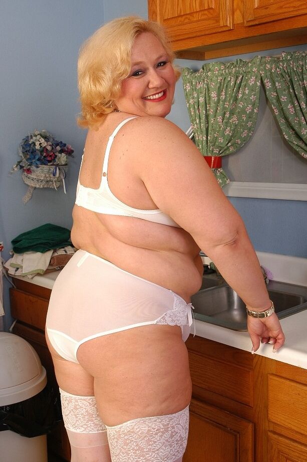 16P Older fat lady Britany models white stockings and underwear in the kitchen