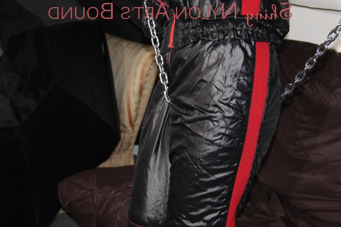 16P Sexy PIA tied and agged overhead with ropes and chains wearing a sexy shiny