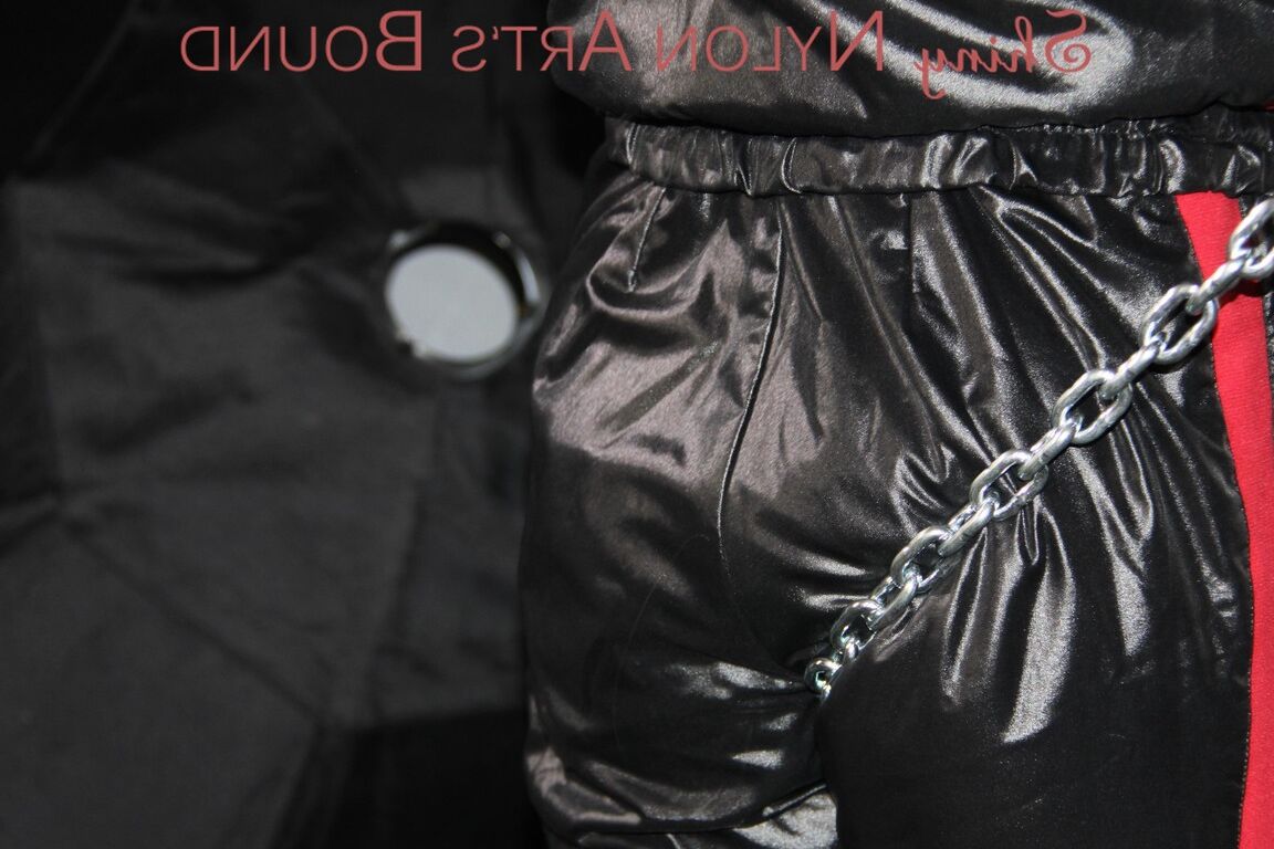 16P Sexy PIA tied and agged overhead with ropes and chains wearing a sexy shiny