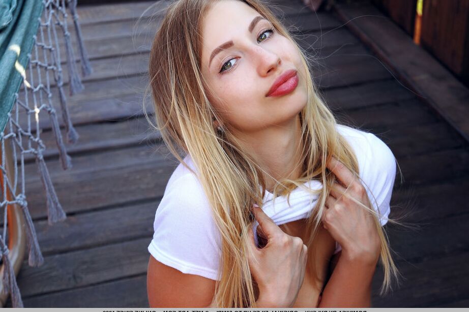 18P Charming teen Dominica gets bare naked on an oceanside dock