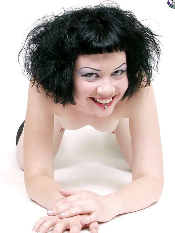 15P Alt girl Verotika removes a corset and sliver skirt to pose nude in boots