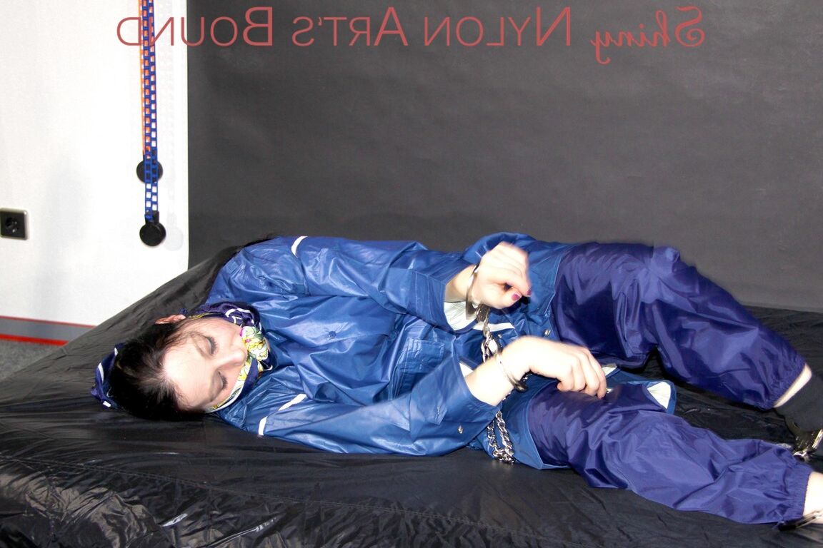 16P Lucy tied with cuffs overhead and gagged with a clothgag wearing sexy blue