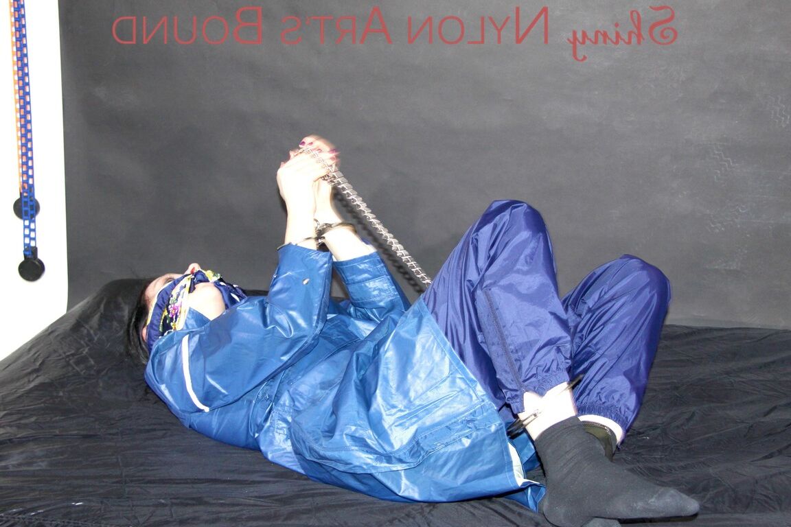 16P Lucy tied with cuffs overhead and gagged with a clothgag wearing sexy blue