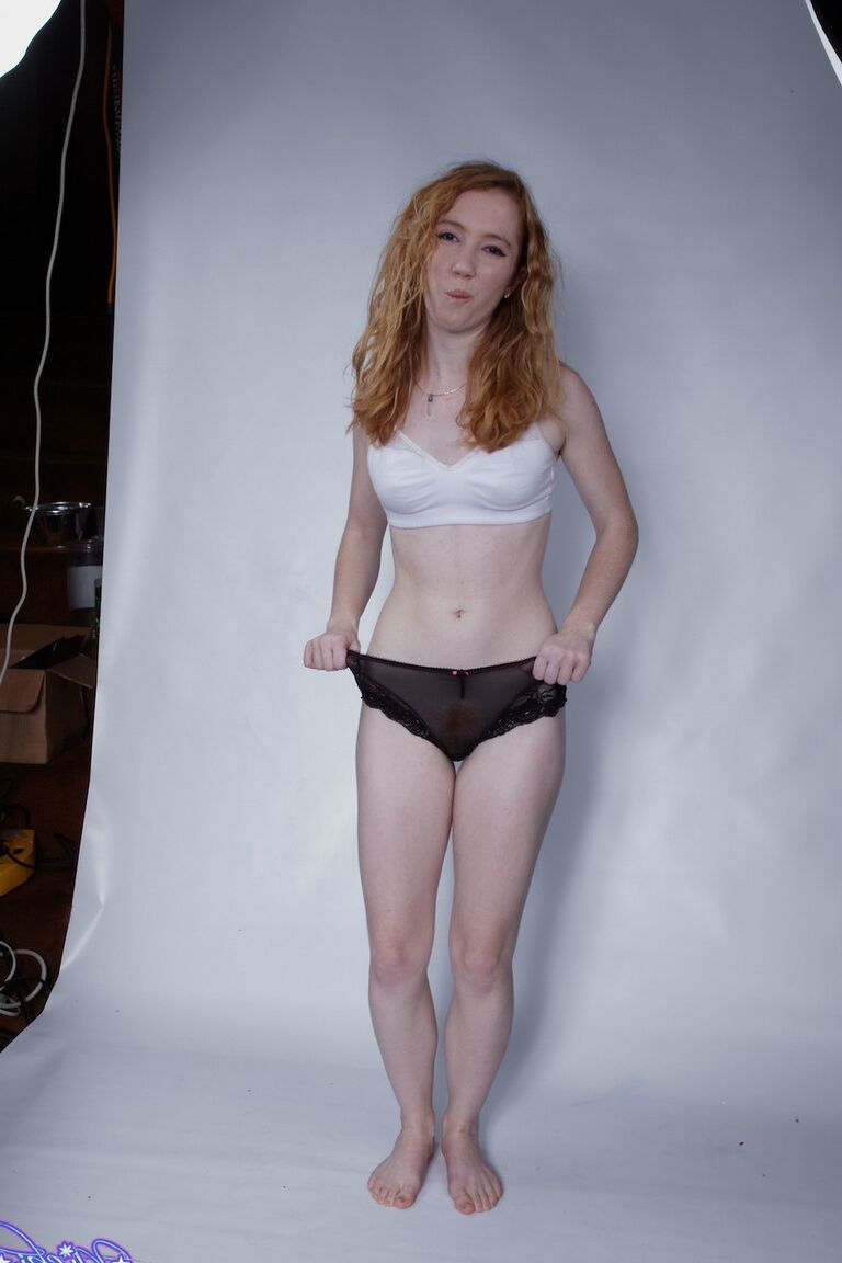 15P Natural redhead Nicki Blue pulls down her black panties during a solo shoot