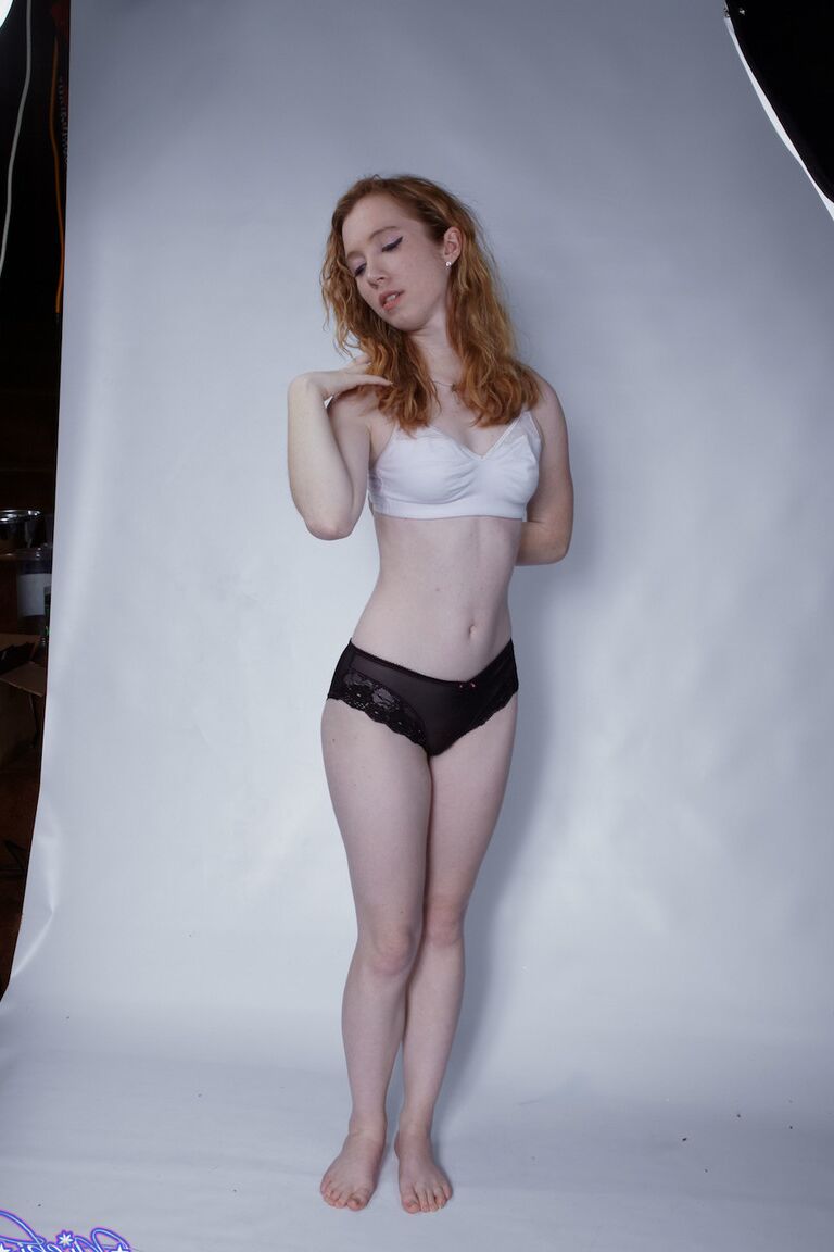 15P Natural redhead Nicki Blue pulls down her black panties during a solo shoot