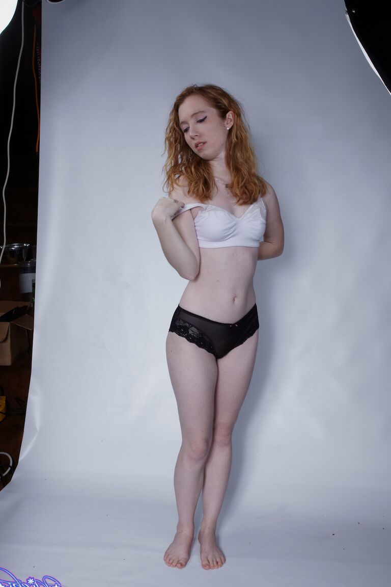 15P Natural redhead Nicki Blue pulls down her black panties during a solo shoot