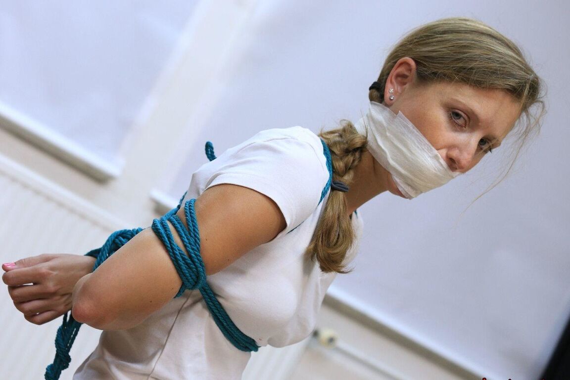 16P Caucasian female is silenced with a gag while tied to a chair in bare feet
