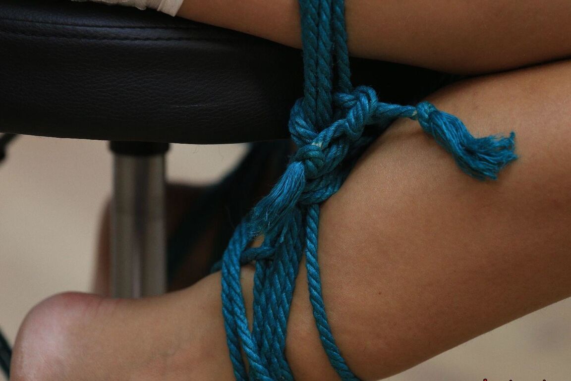 16P Caucasian female is silenced with a gag while tied to a chair in bare feet