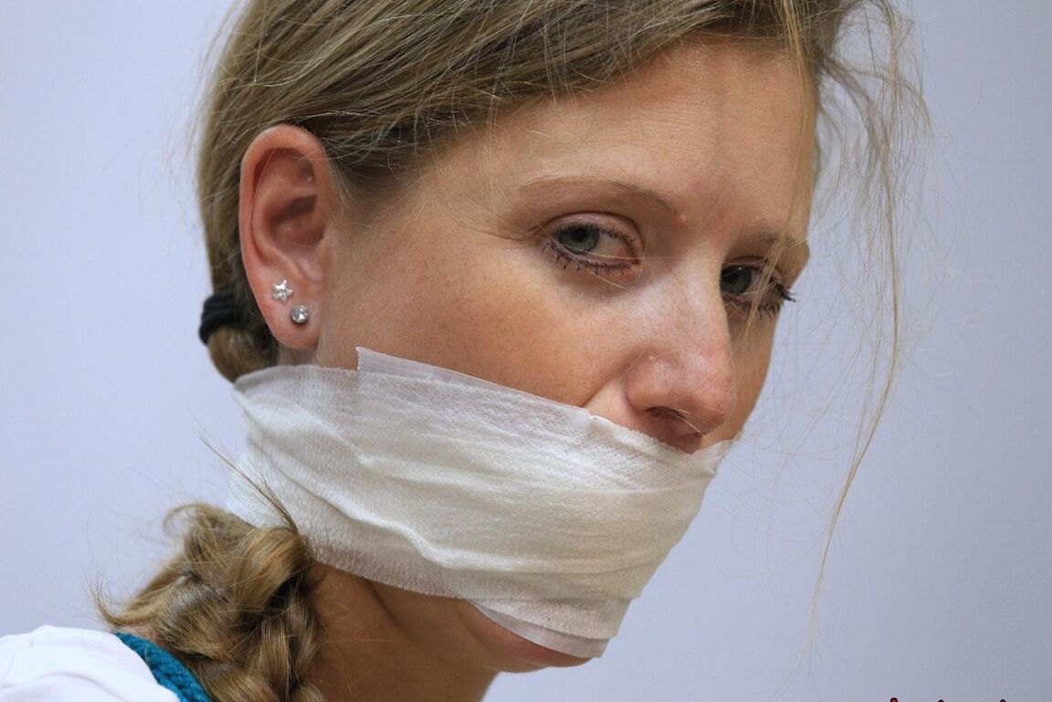 16P Caucasian female is silenced with a gag while tied to a chair in bare feet