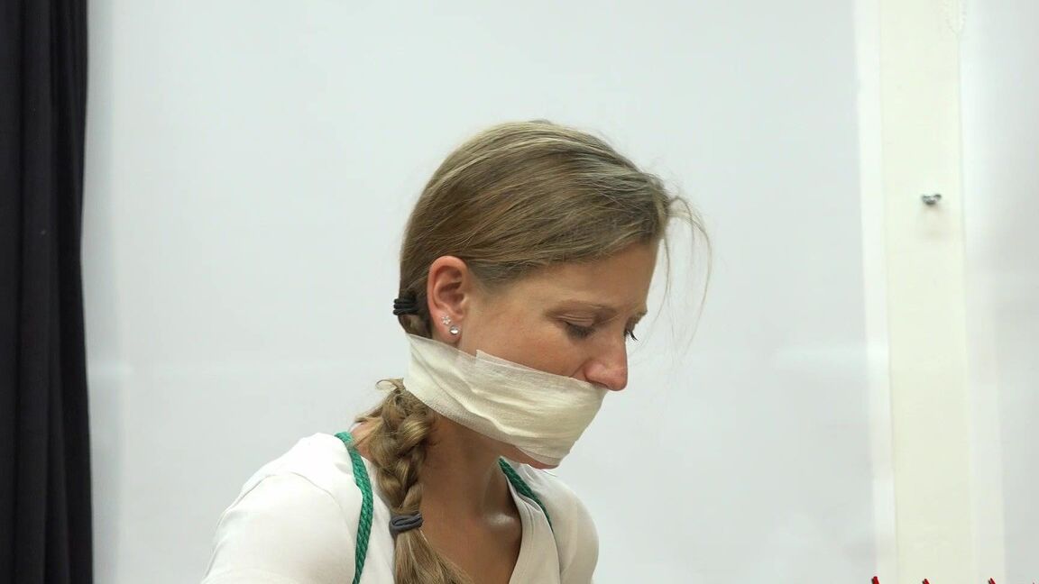 16P Caucasian female is silenced with a gag while tied to a chair in bare feet