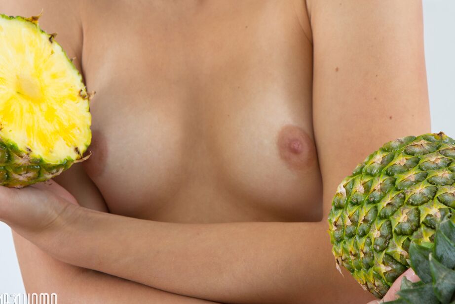20P Sweet teen Barbie holds a split pineapple while getting totally naked