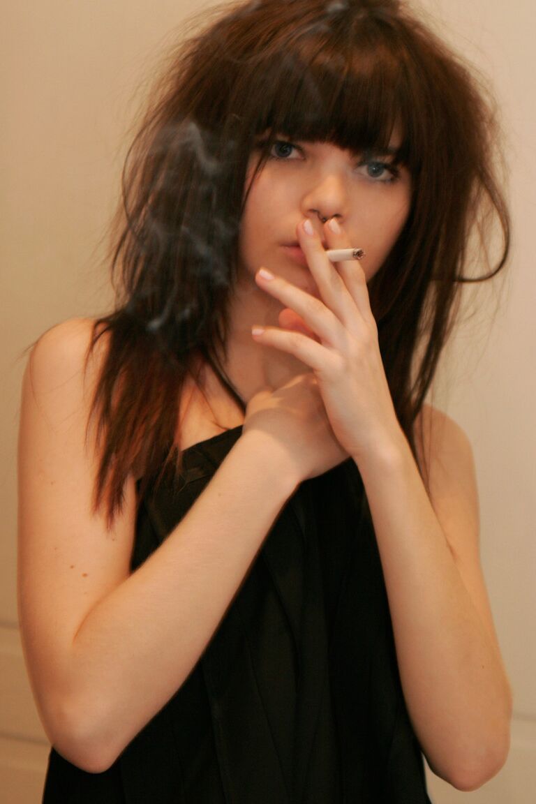 15P Petite girl Kaira 18 smokes while getting totally naked behind a closed door