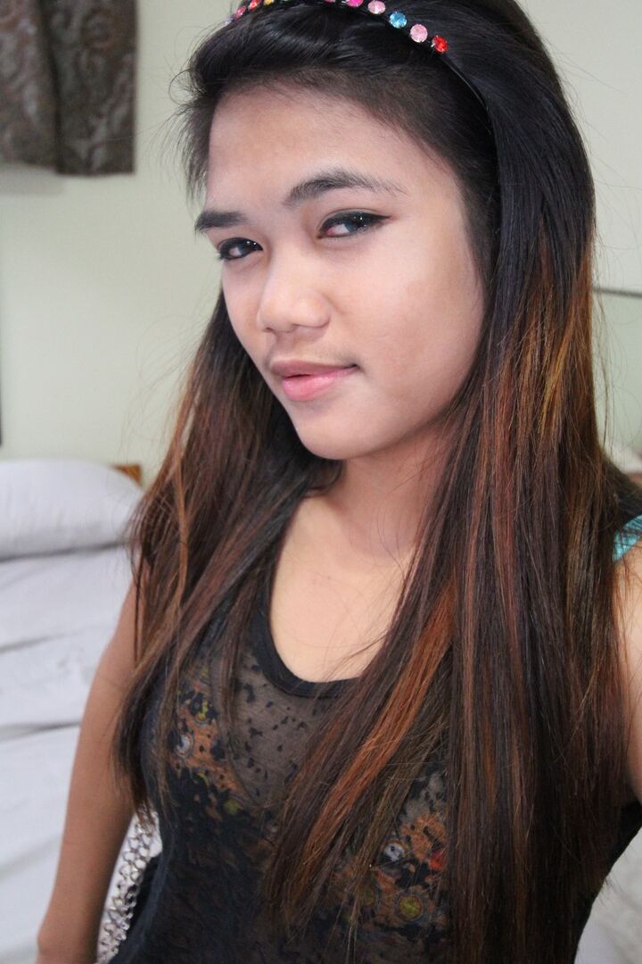 15P Young Filipina girl with a saucy look stands naked after undressing