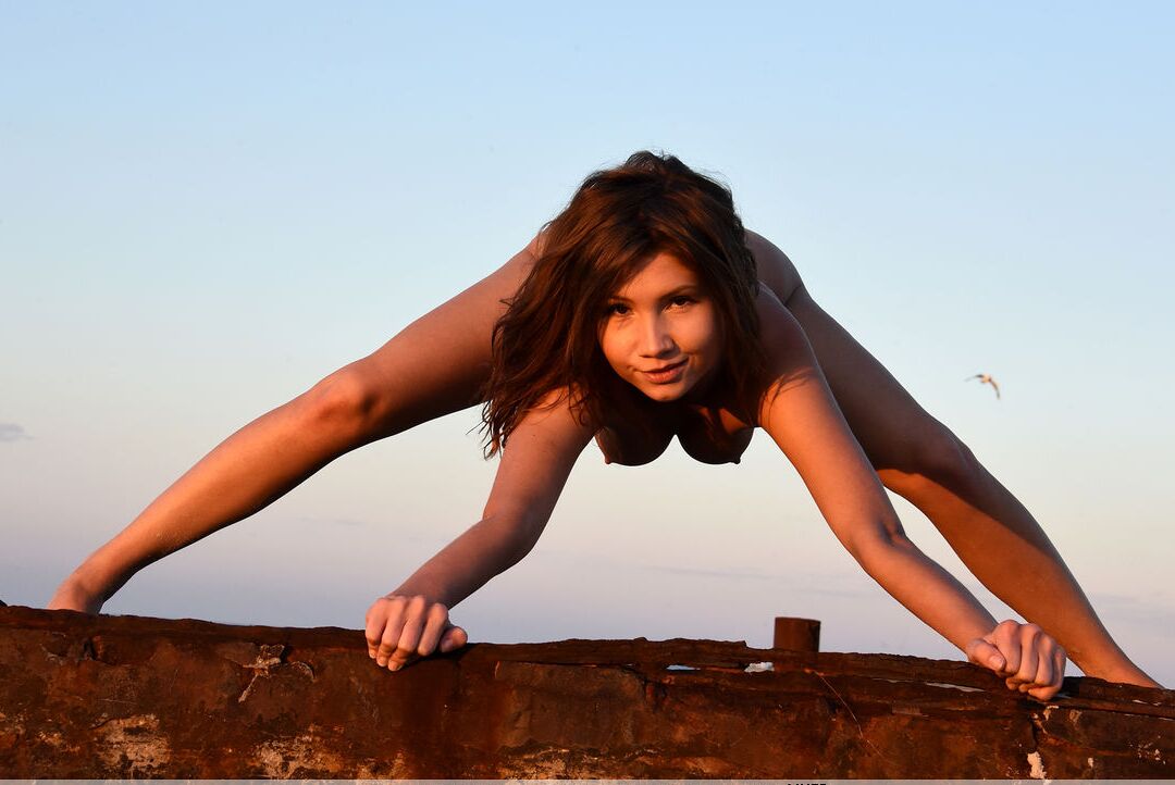 16P Petite white chick Arlene V models naked in the sand beside the ocean