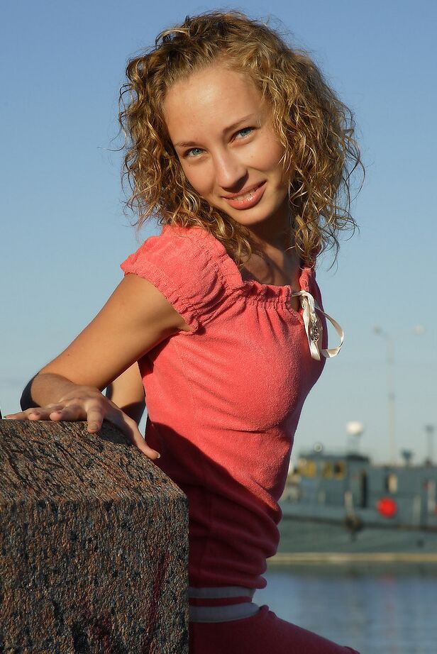 12P Curly haired girl exposes her pussy and small tits while hanging out on a pier