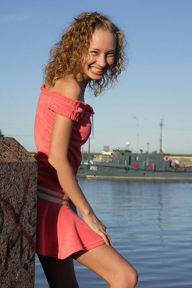 12P Curly haired girl exposes her pussy and small tits while hanging out on a pier
