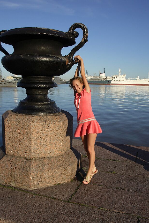 12P Curly haired girl exposes her pussy and small tits while hanging out on a pier