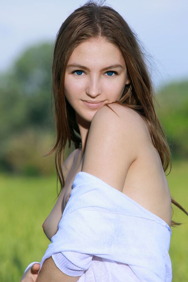 18P Nice teen Izabel A holds a flower after getting naked in a field