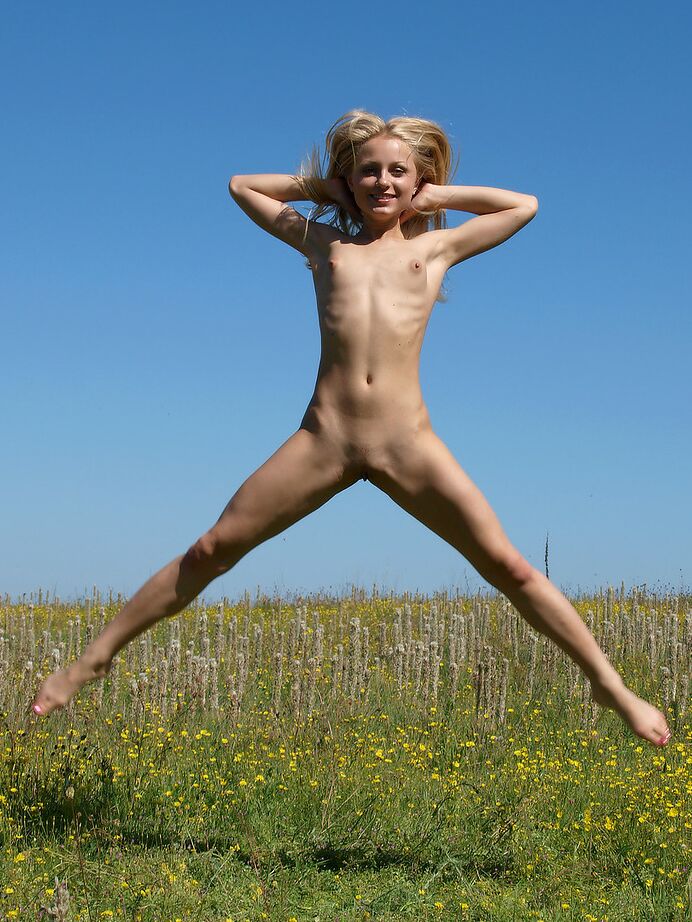 12P Skinny blonde girl romps around in a field of wild flowers and weeds