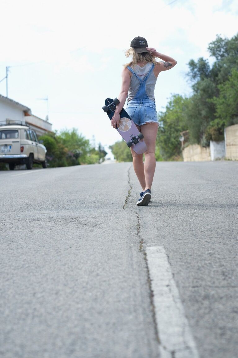 12P La patineuse blonde Pippa Doll se déshabille avant de descendre dans une rue pavée.