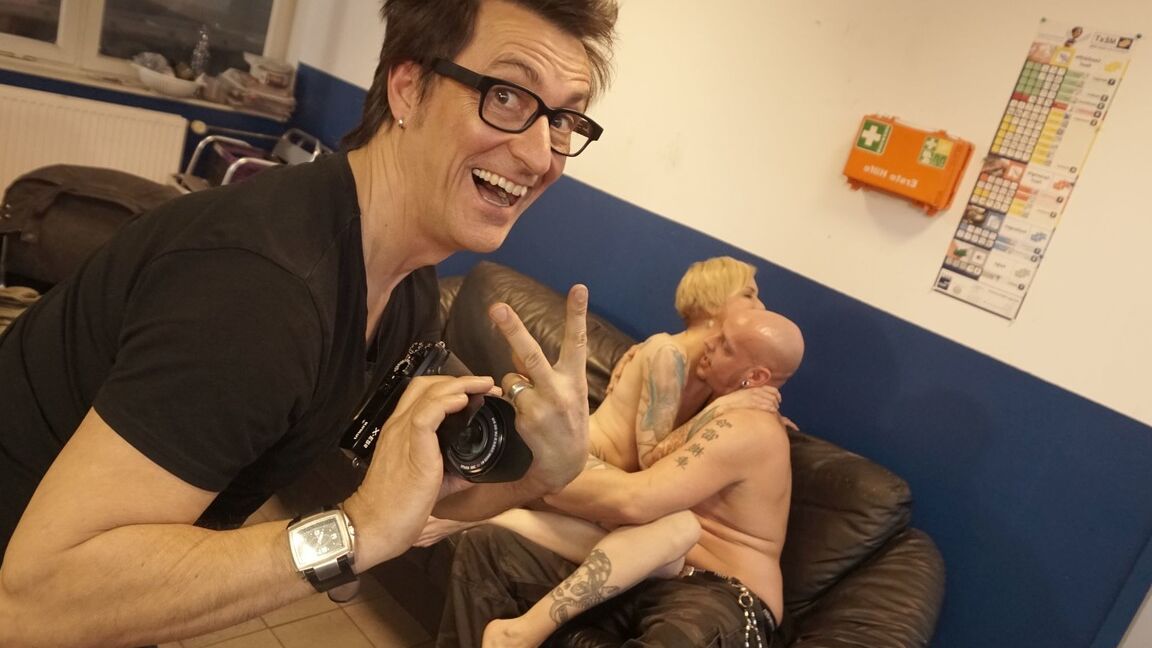 21P Tattooed slut Conny Dachs gets sandwiched by two perverts on the sofa