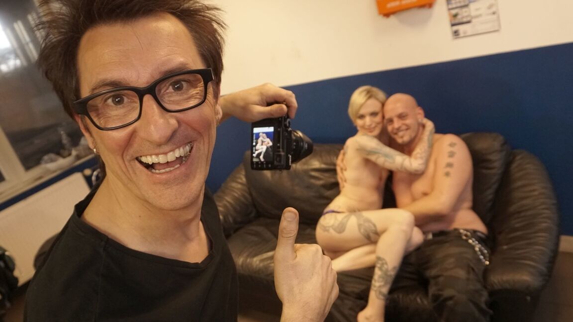 21P Tattooed slut Conny Dachs gets sandwiched by two perverts on the sofa