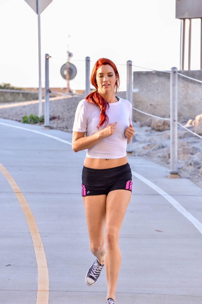 17P Hot redhead flashes her big tits while out jogging in spandex shorts