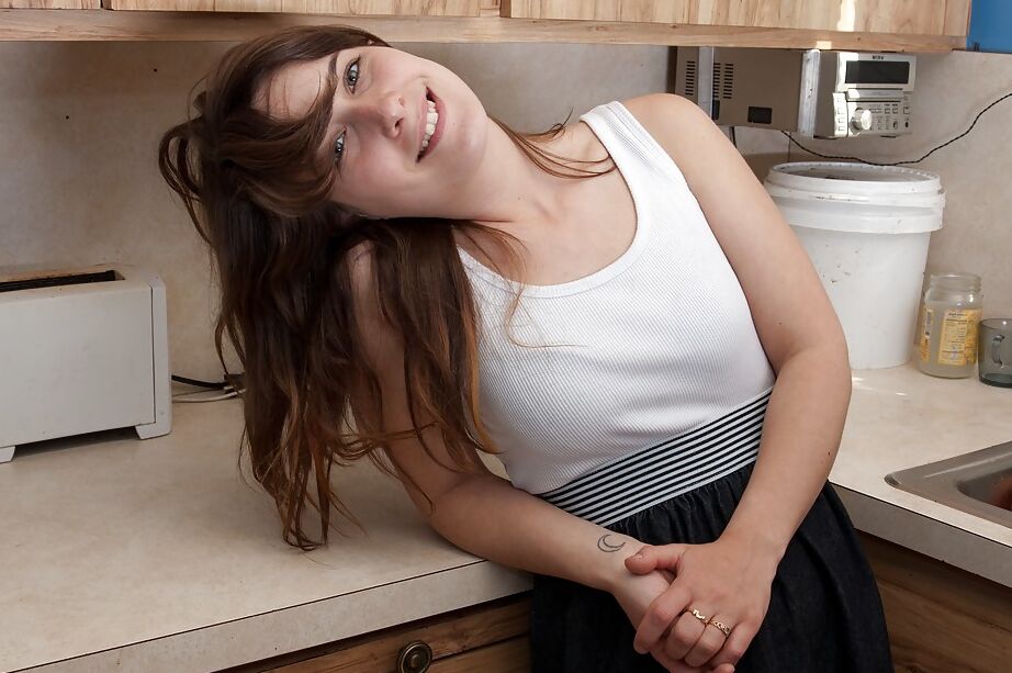 16P Lusty babe Nixi stripping and masturbating her cunt in the kitchen