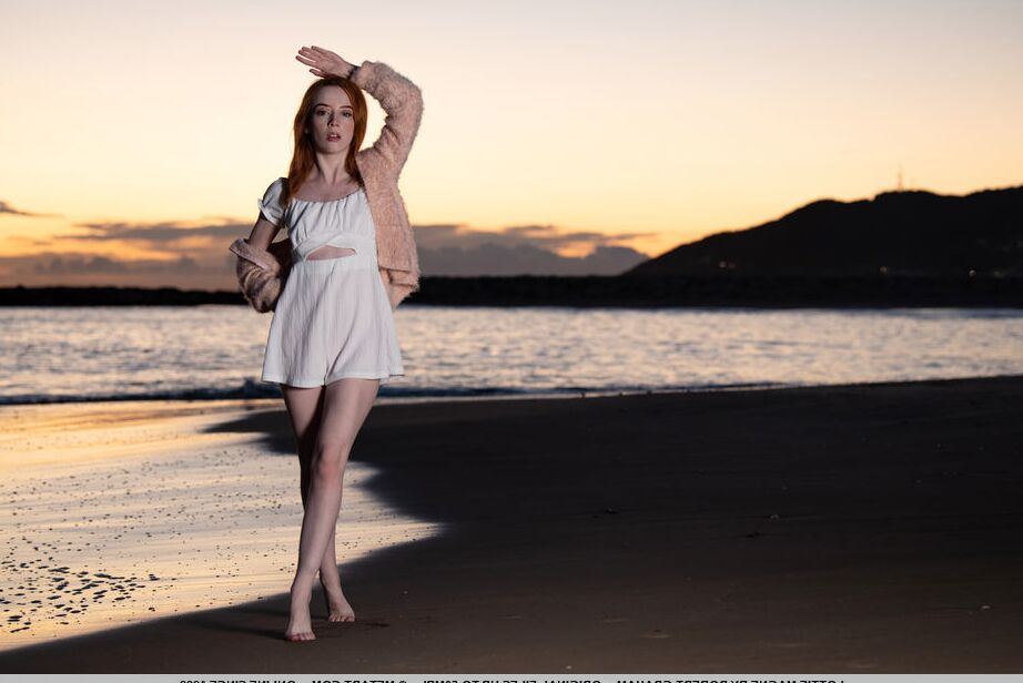 18P Young redhead Lottie Magne gets totally naked after walking a beach at sunset