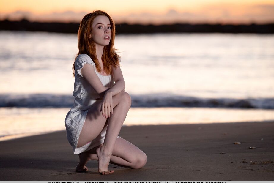 18P Young redhead Lottie Magne gets totally naked after walking a beach at sunset