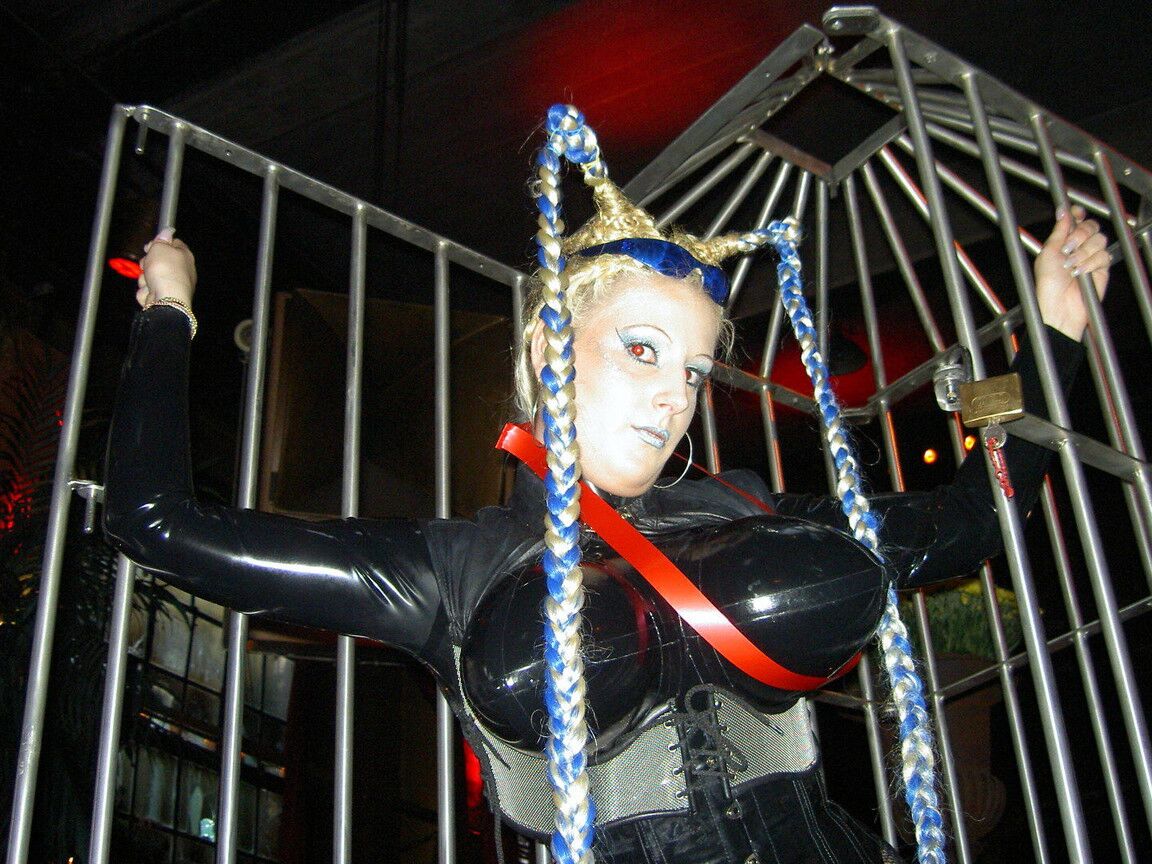 16P Fetish model Dark Wing poses in kinky latex wear and ripped hosiery