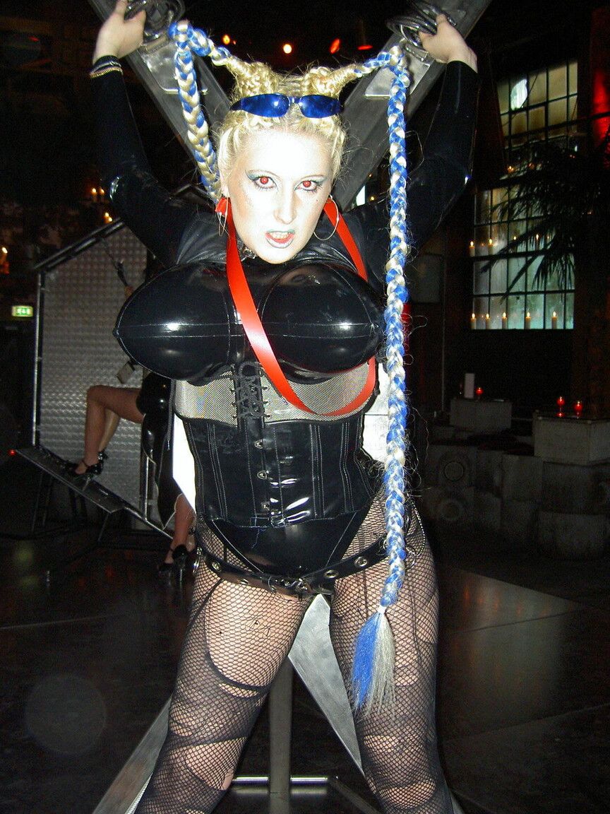 16P Fetish model Dark Wing poses in kinky latex wear and ripped hosiery