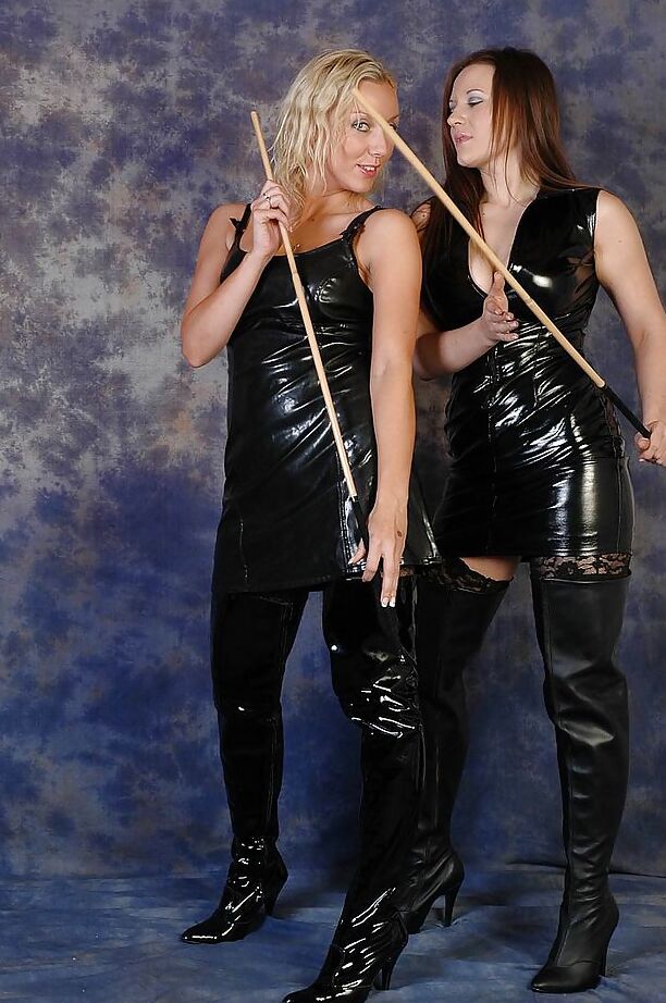 16P Non nude Dominatrixes in latex and leather boots whip each others ass