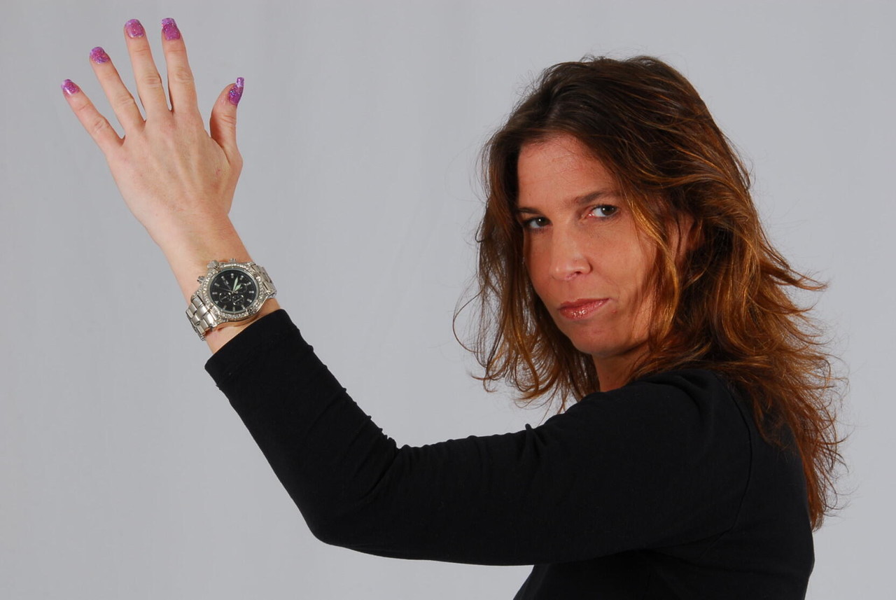 16P Caucasian model Felicia takes a glance at her huge metal watch while dressed