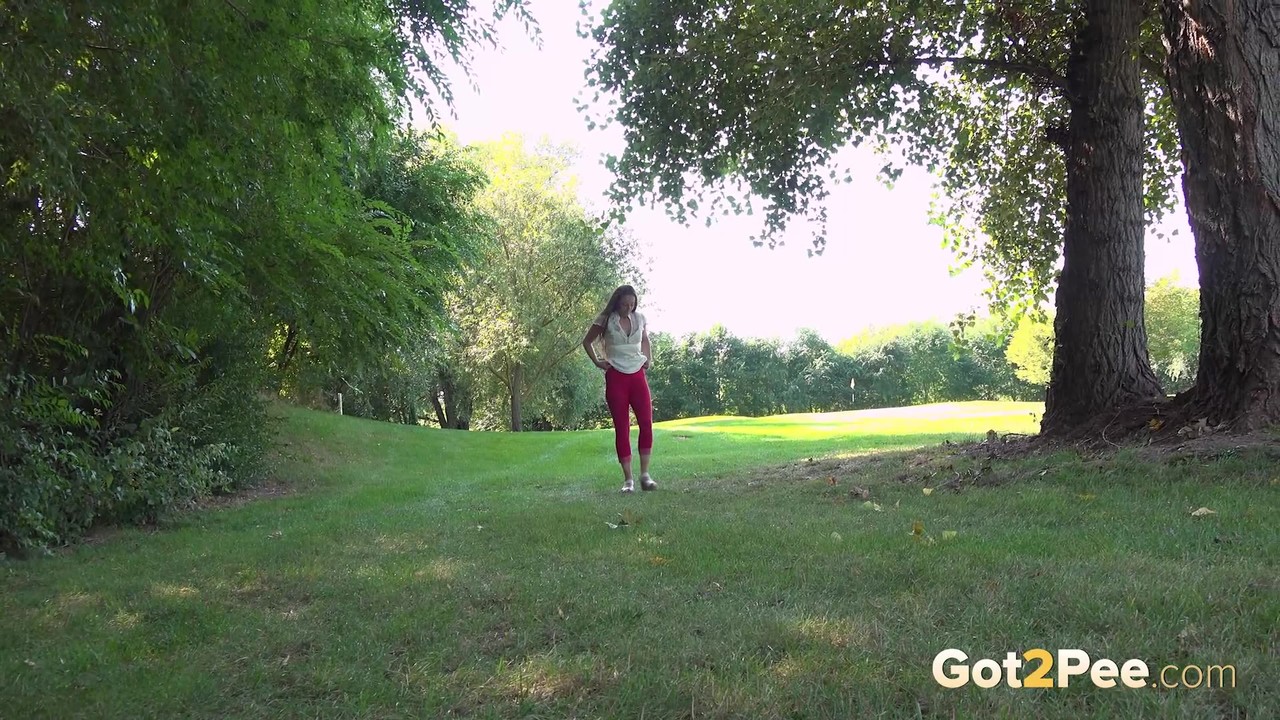 15P Caucasian girl Valentina Ross squats for a piss behind a tree in a park