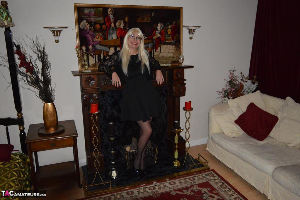 20P Mature blonde Barby Slut gets naked on a sofa in garters and nylons