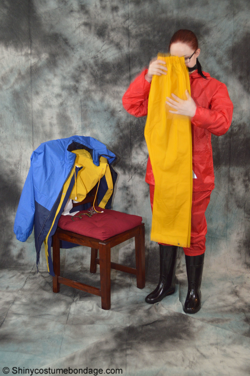16P Pale redhead Lady Nadja dons a cleave gag while wearing rain suits