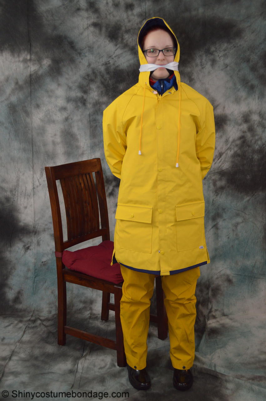 16P Pale redhead Lady Nadja dons a cleave gag while wearing rain suits