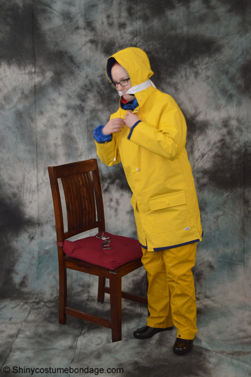 16P Pale redhead Lady Nadja dons a cleave gag while wearing rain suits