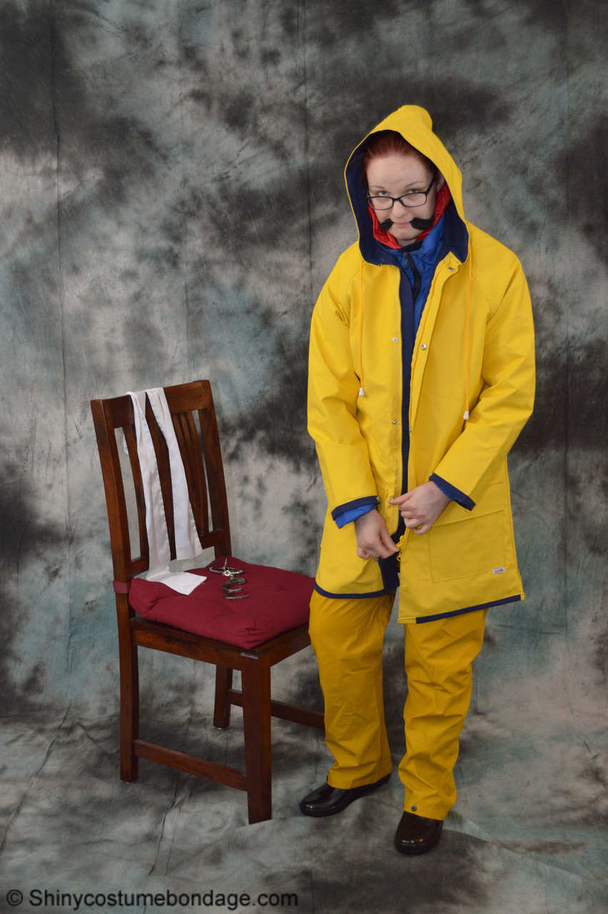 16P Pale redhead Lady Nadja dons a cleave gag while wearing rain suits