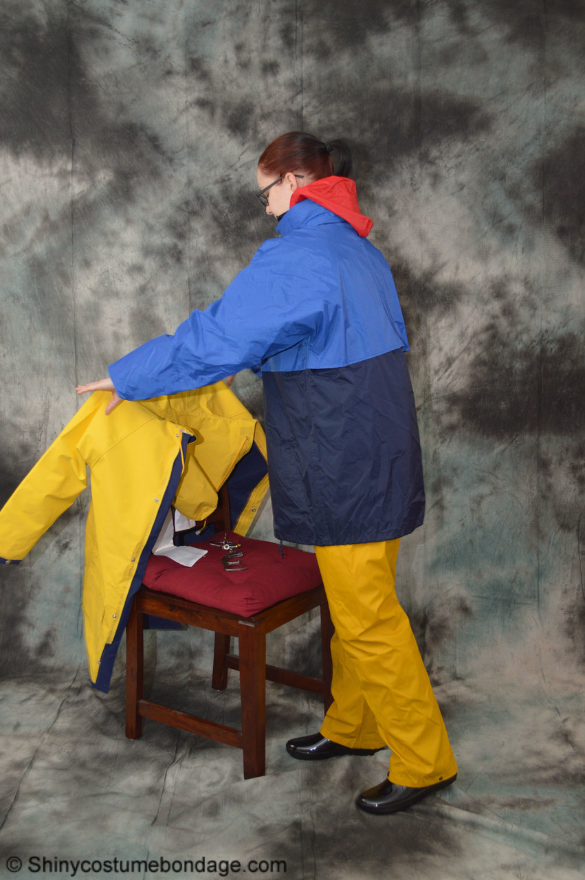 16P Pale redhead Lady Nadja dons a cleave gag while wearing rain suits