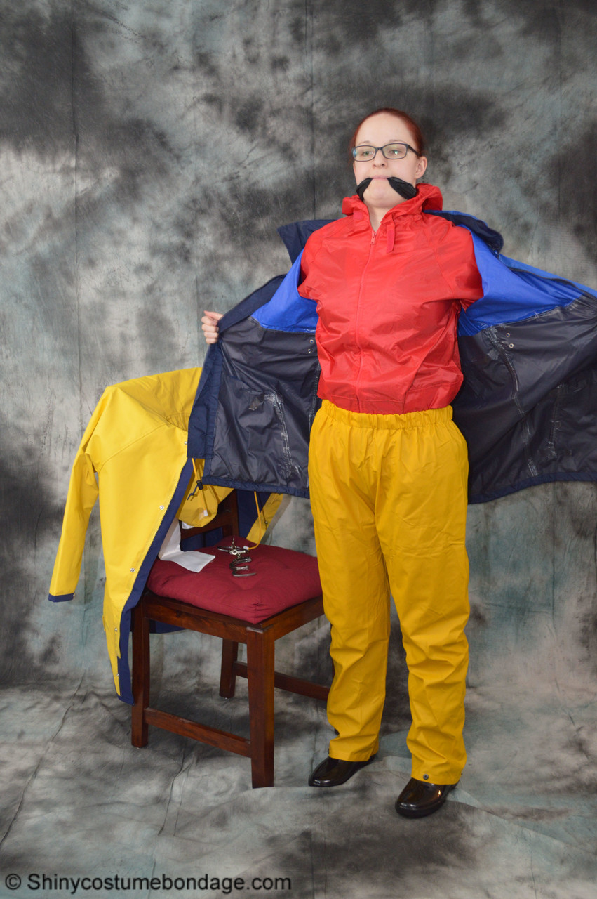 16P Pale redhead Lady Nadja dons a cleave gag while wearing rain suits