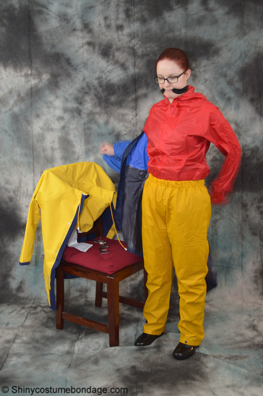 16P Pale redhead Lady Nadja dons a cleave gag while wearing rain suits