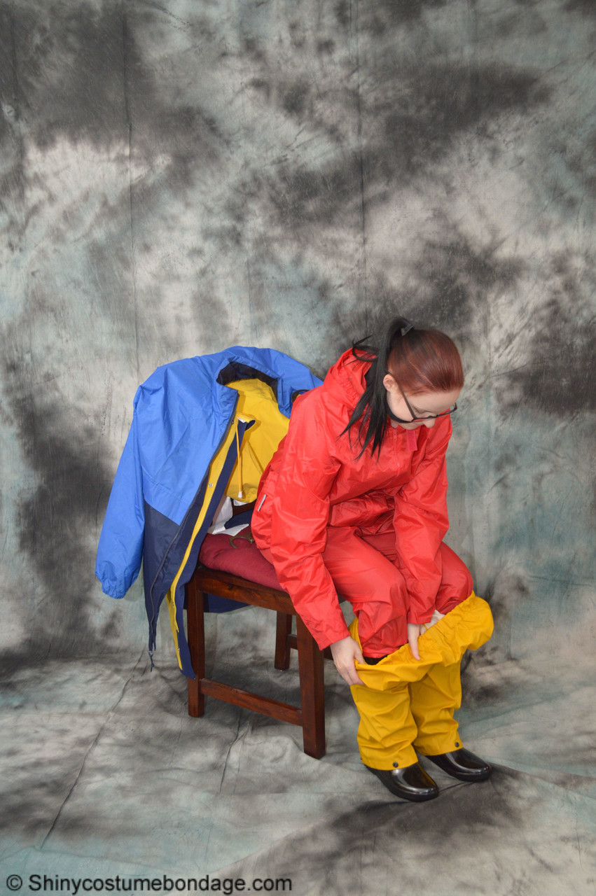 16P Pale redhead Lady Nadja dons a cleave gag while wearing rain suits